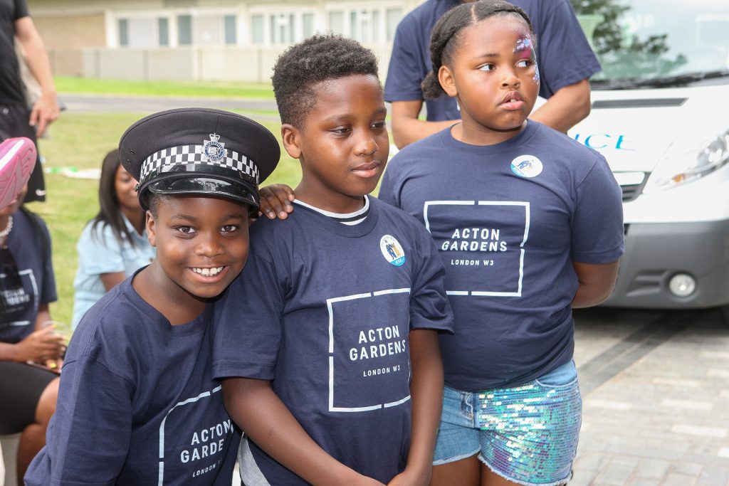 A group of children in blue t - shirts posing for a photo.
