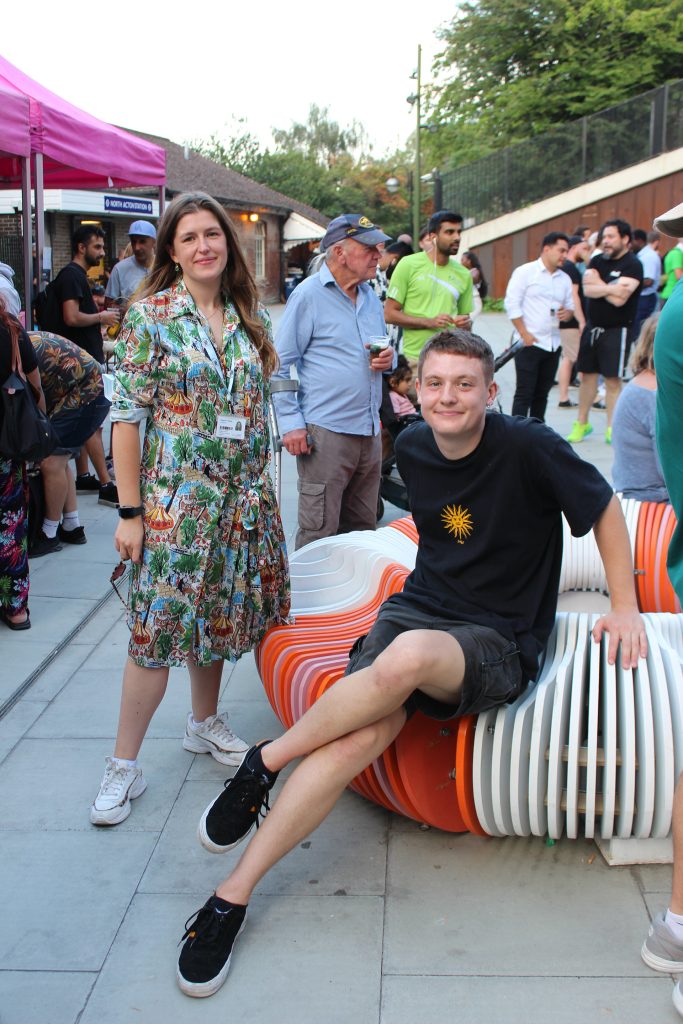 A group of people sitting on a bench.