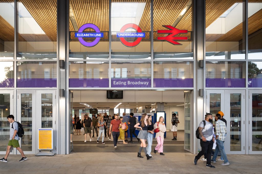 A group of people walking through a subway station.