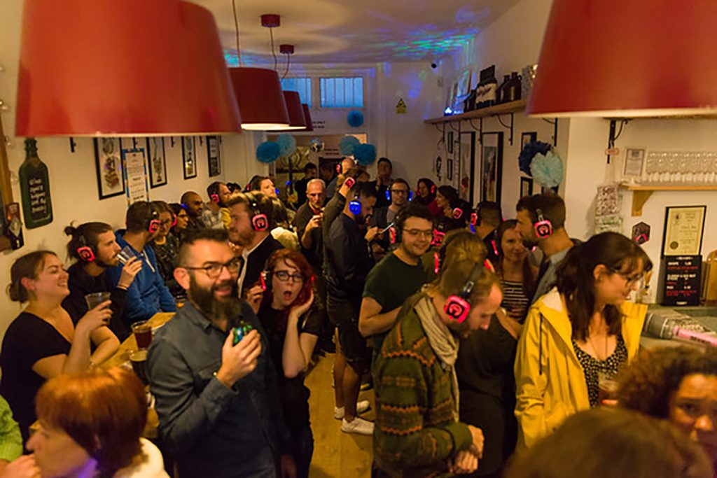A group of people standing in a room.