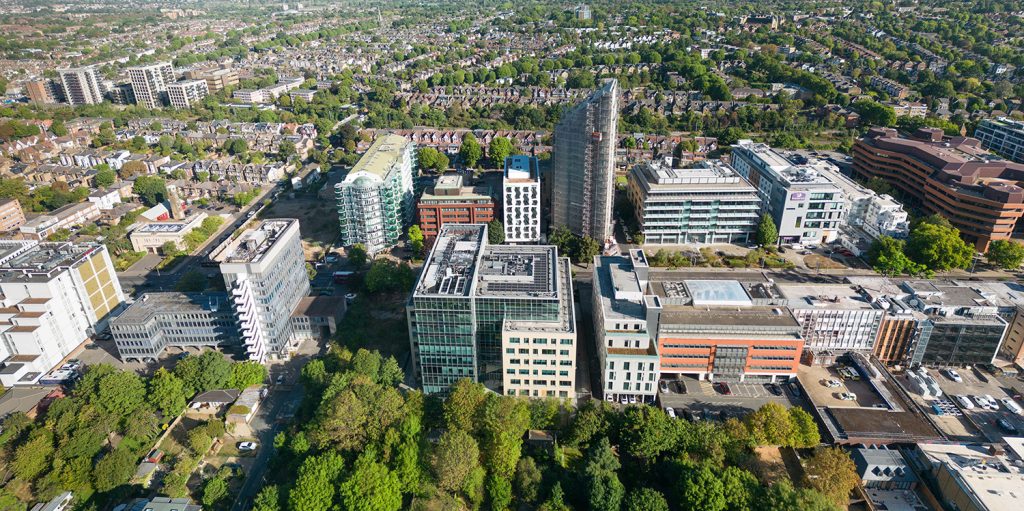 An aerial view of a city with tall buildings and trees.