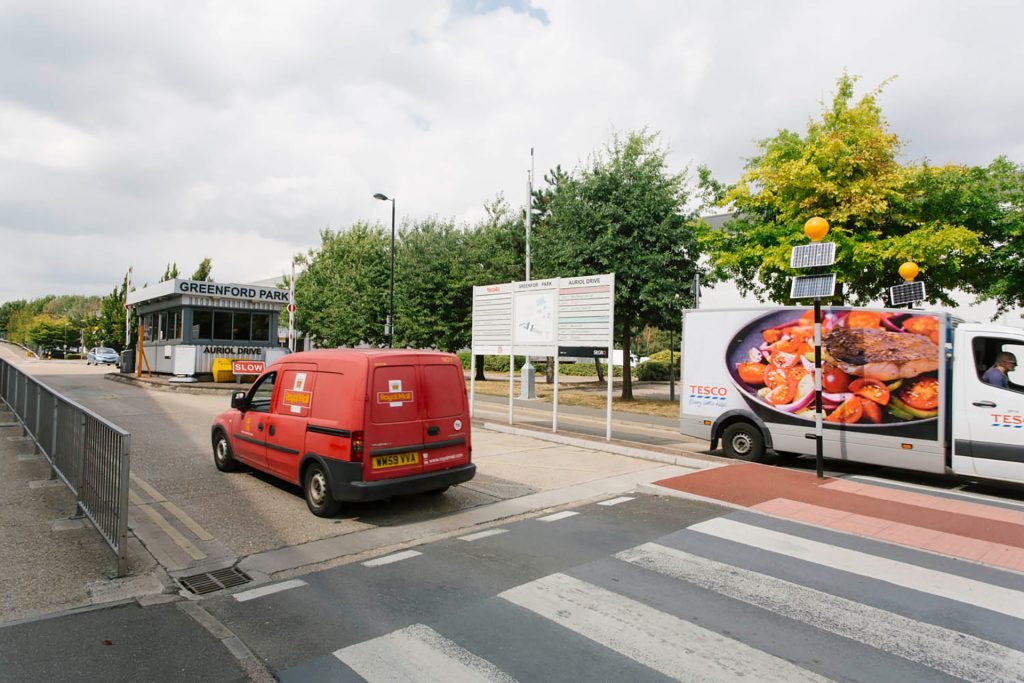 A red truck driving down a street.